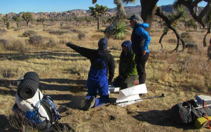 a group of veterans practice navigation on an outward bound veterans course
